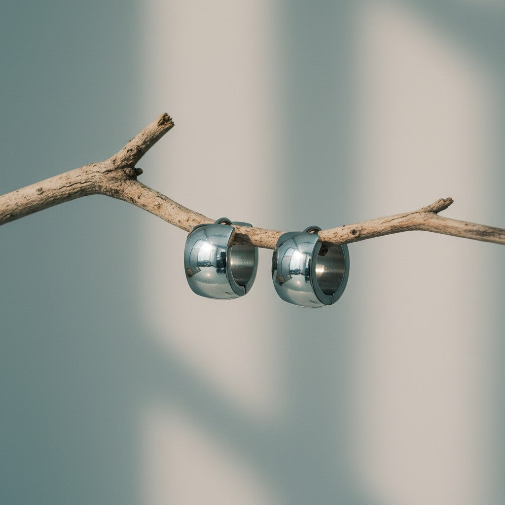 Aramat Jewels small silver-colored stainless steel hoop earrings, 13mm diameter, 7mm width, polished finish.