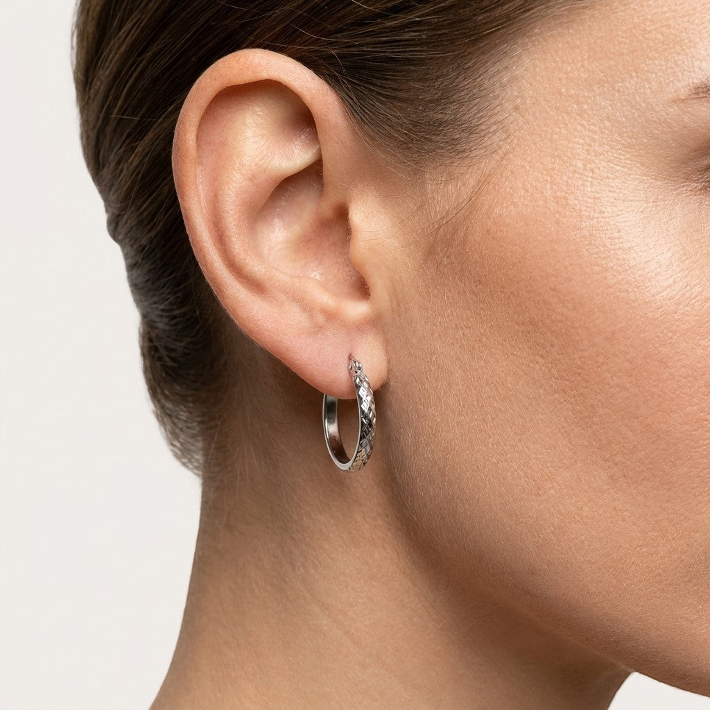 Aramat Jewels silver-tone stainless steel hoop earrings with a 30mm diameter and a textured diamond pattern.