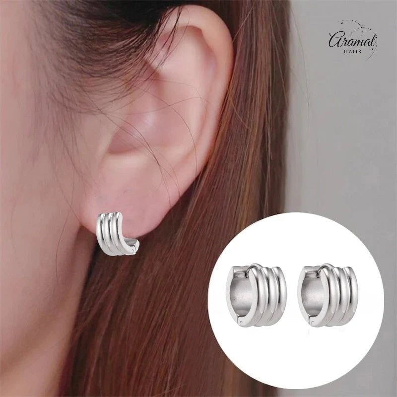 Aramat Jewels wide silver-tone stainless steel hoop earrings with three parallel ridges, 13x7mm.