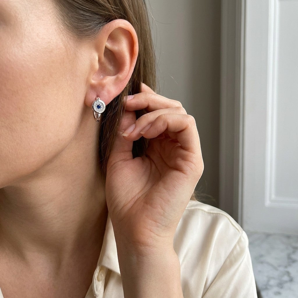 Aramat Jewels silver hoop earrings with blue and clear cubic zirconia, 12mm diameter.