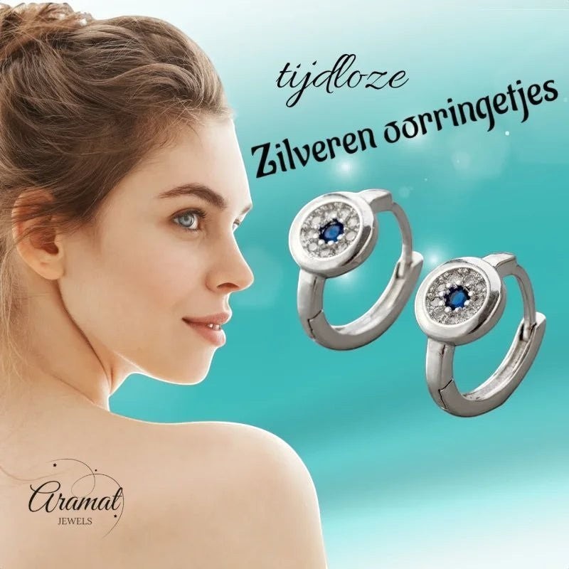 Aramat Jewels silver hoop earrings with blue and clear cubic zirconia, 12mm diameter.