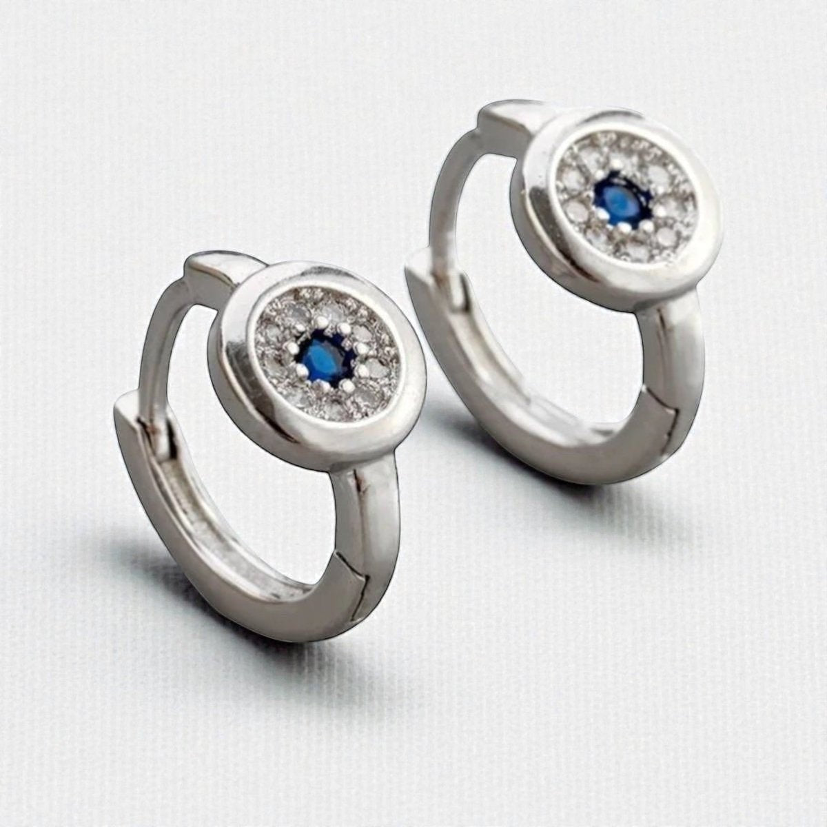 Aramat Jewels silver hoop earrings with blue and clear cubic zirconia, 12mm diameter.