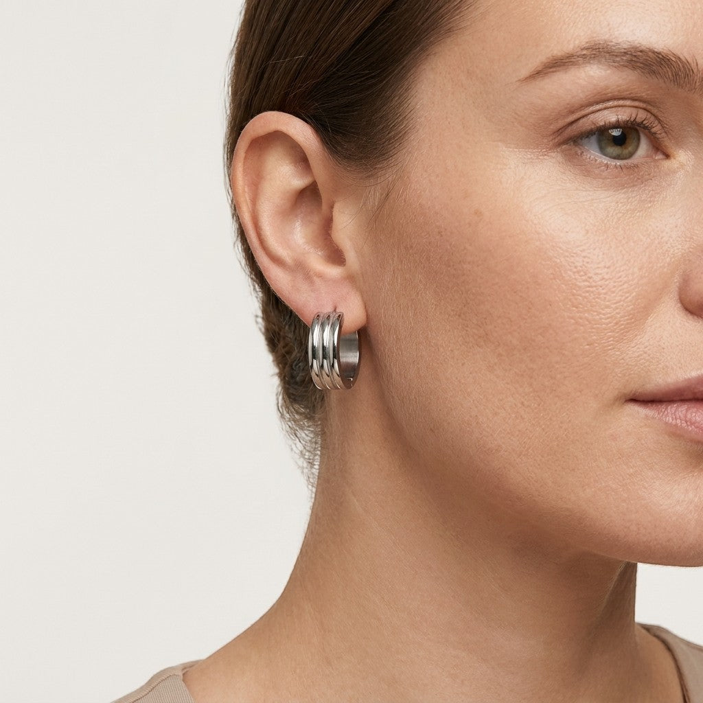 Aramat Jewels wide silver-tone stainless steel hoop earrings with ribbed detail, 20mm diameter.