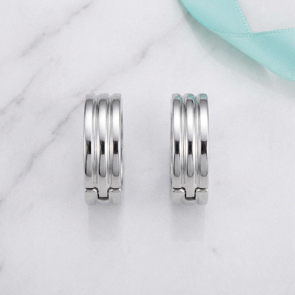 Aramat Jewels wide silver-tone stainless steel hoop earrings with ribbed detail, 20mm diameter.