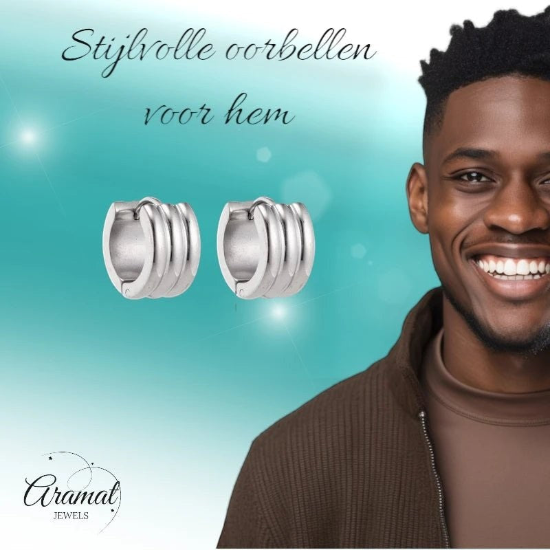 Aramat Jewels silver-colored stainless steel hoop earrings with ribbed detail, worn by a smiling man.