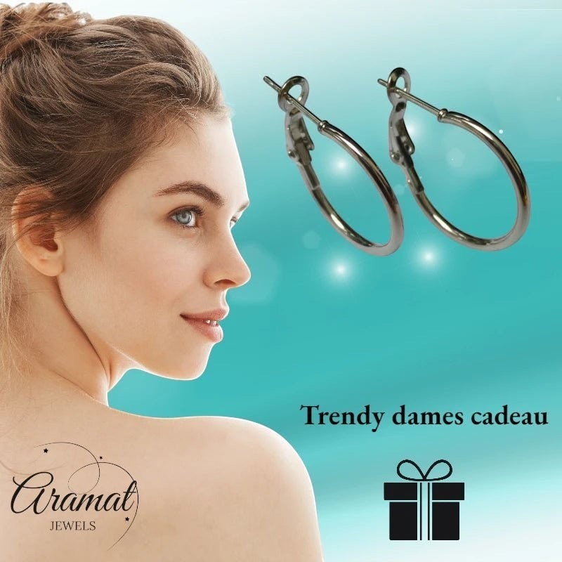 Aramat Jewels silver-tone stainless steel hoop earrings with a high-gloss finish, shown on a model.