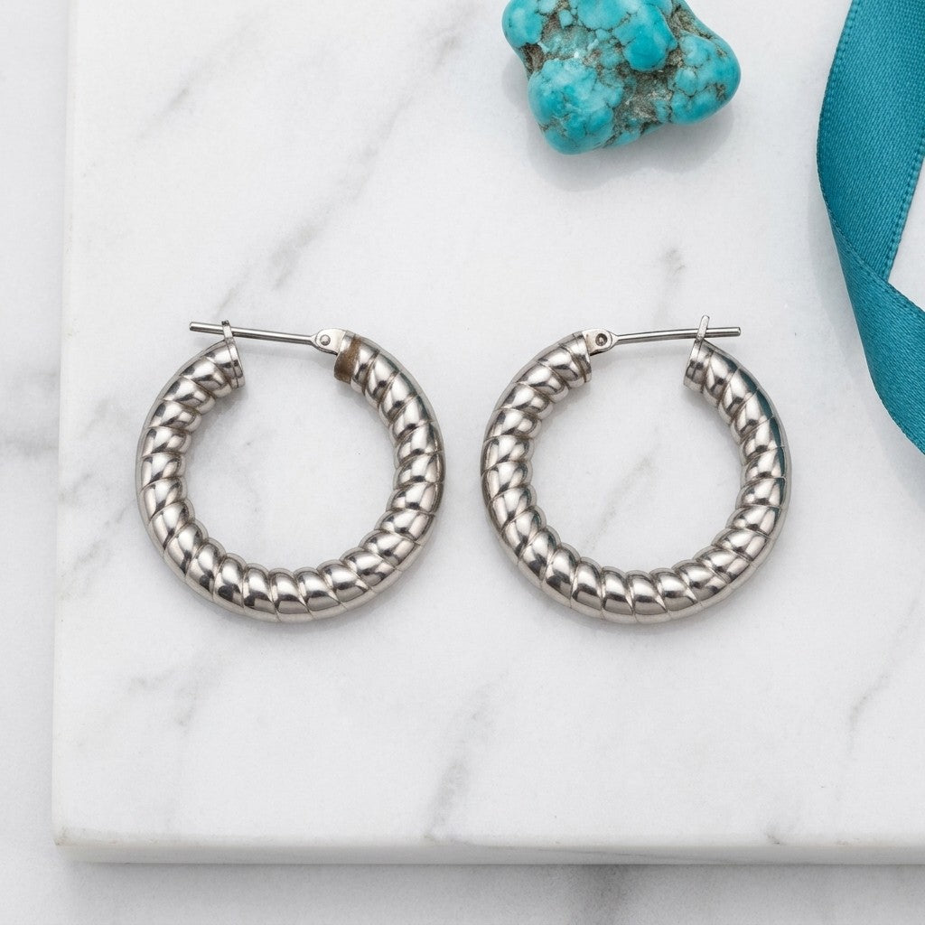 Aramat Jewels silver-coloured hollow hoop earrings with a textured stripe motif, 30mm diameter.
