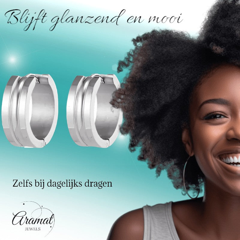 Aramat Jewels silver-colored stainless steel hoop earrings with a dynamic stripe design, 19mm diameter, 7mm width, and a polished finish.