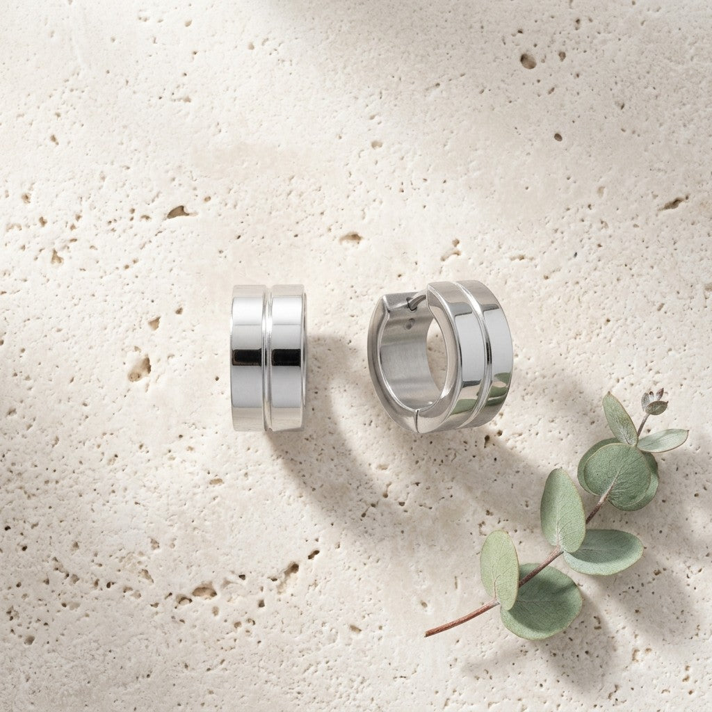Aramat Jewels silver-tone stainless steel huggie hoop earrings with a double-band design and subtle accent.