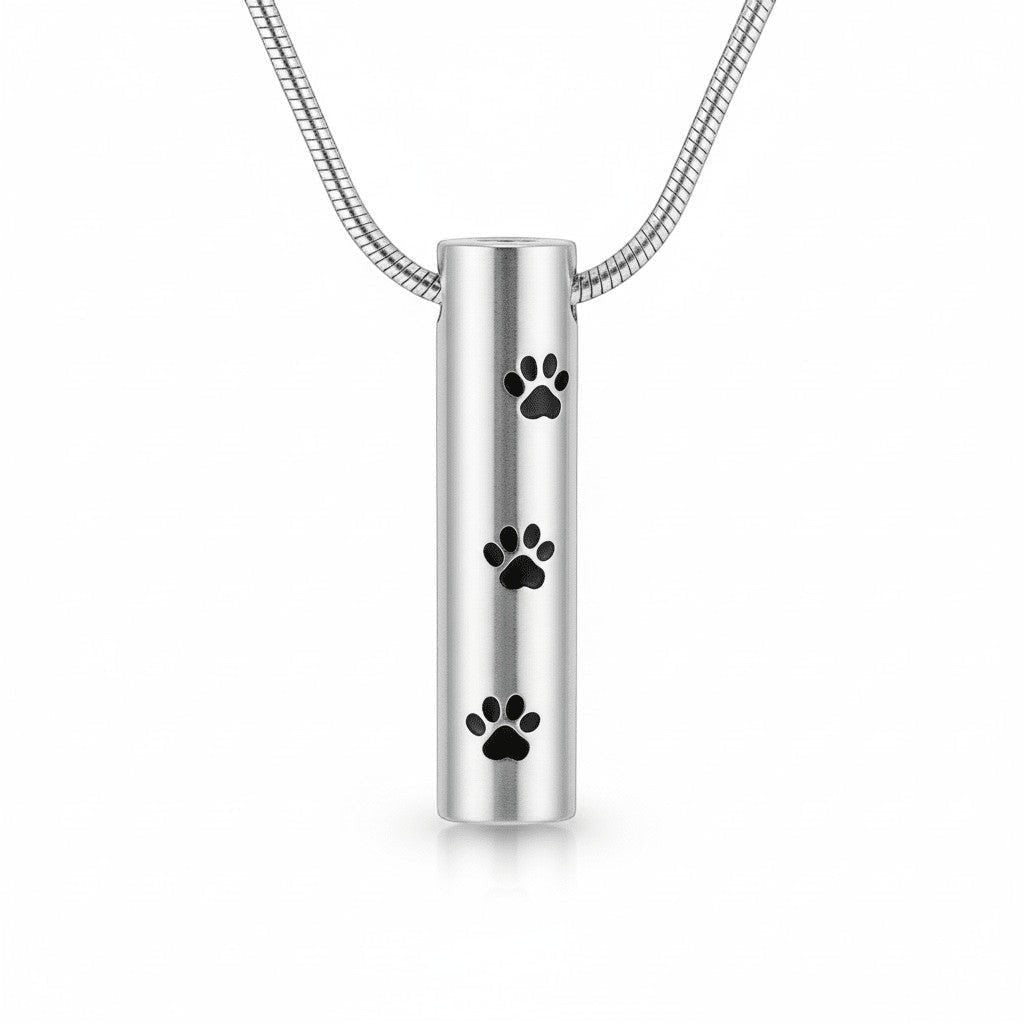 Aramat Jewels silver-colored stainless steel cylinder cremation pendant with black paw prints, 3.4cm