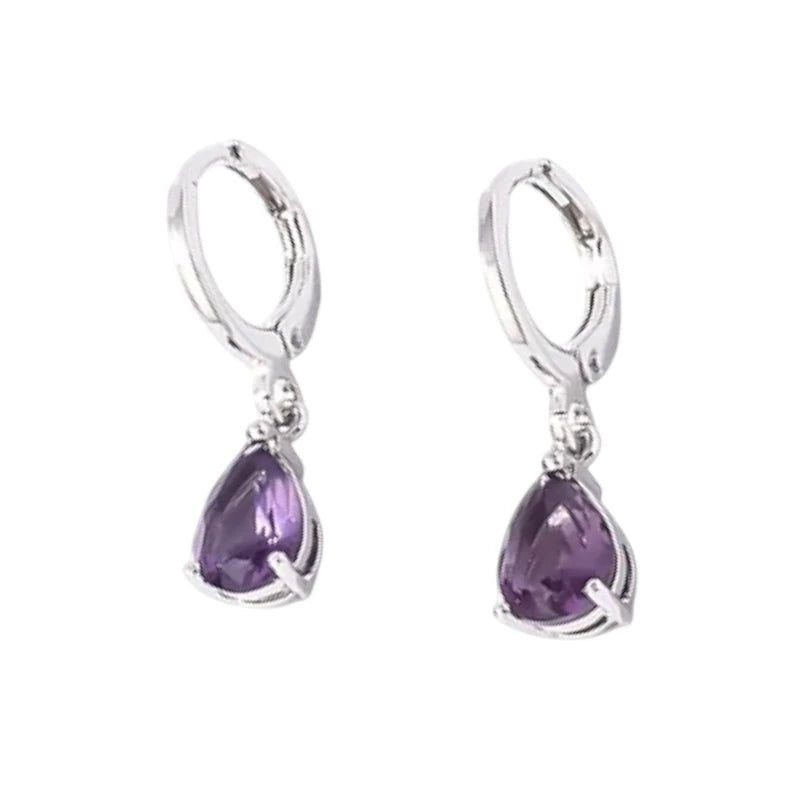 Aramat Jewels silver-tone stainless steel huggie hoop earrings with dangling purple teardrop zirconia stones.