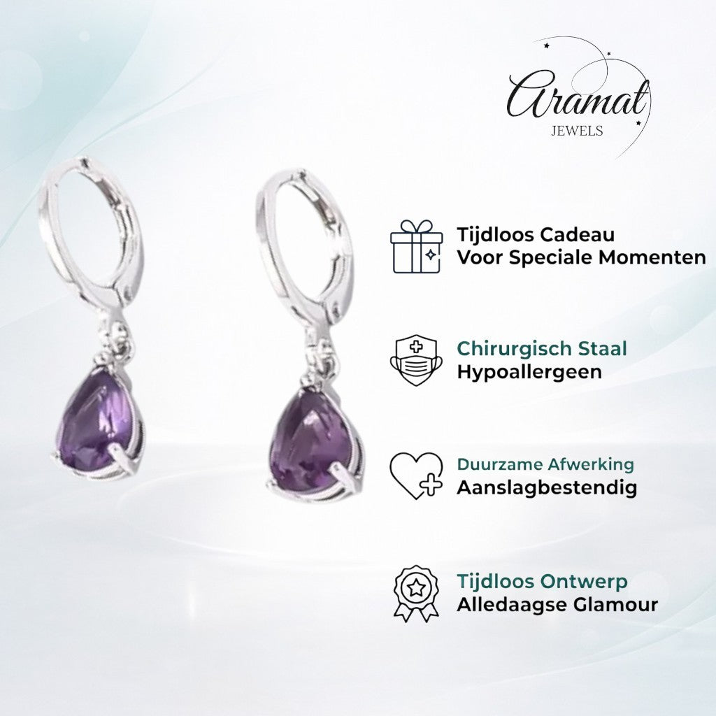 Aramat Jewels silver stainless steel huggie earrings with dangling purple teardrop zirconia stones.