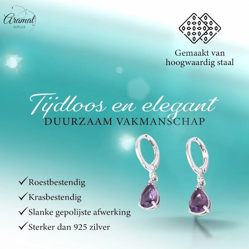 Aramat Jewels silver stainless steel huggie earrings with dangling purple teardrop zirconia stones on a teal background.