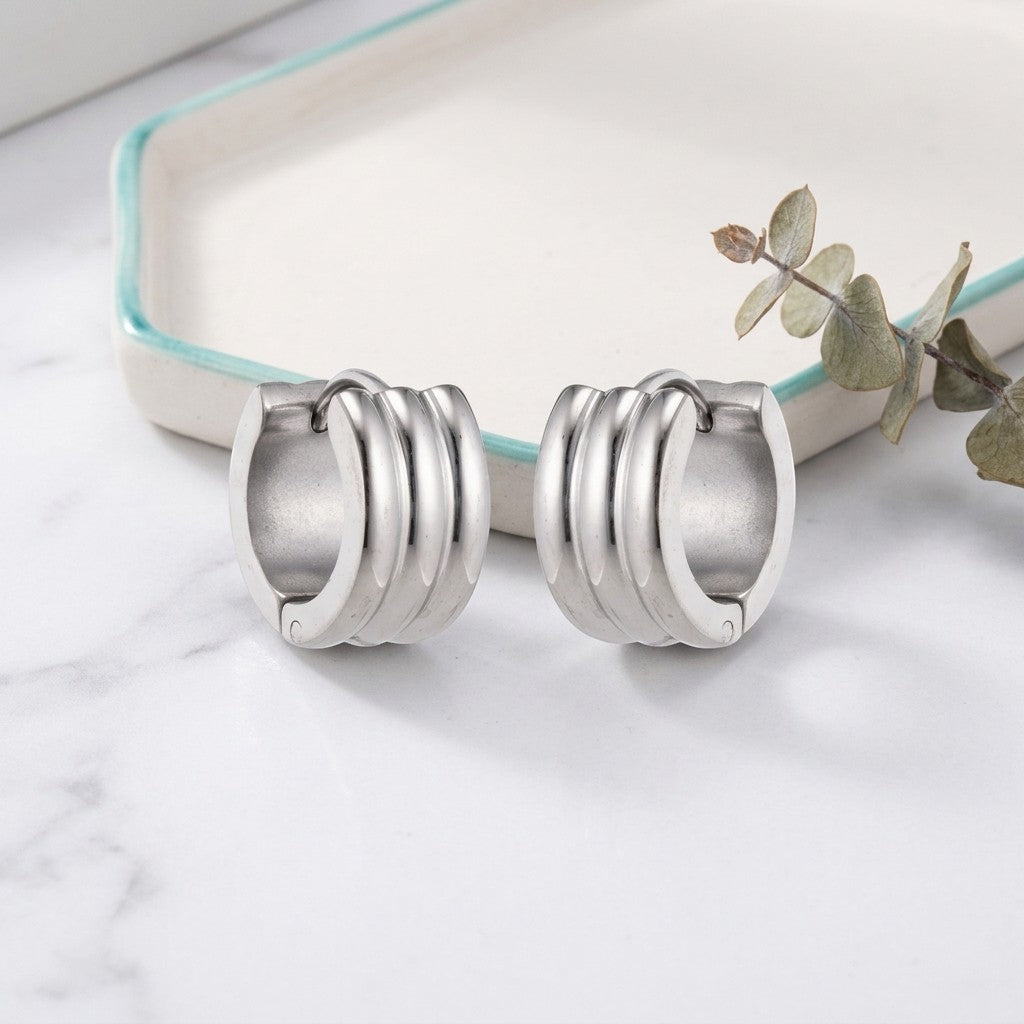 Aramat Jewels wide silver-tone stainless steel hoop earrings with ribbed texture, 13x7mm.