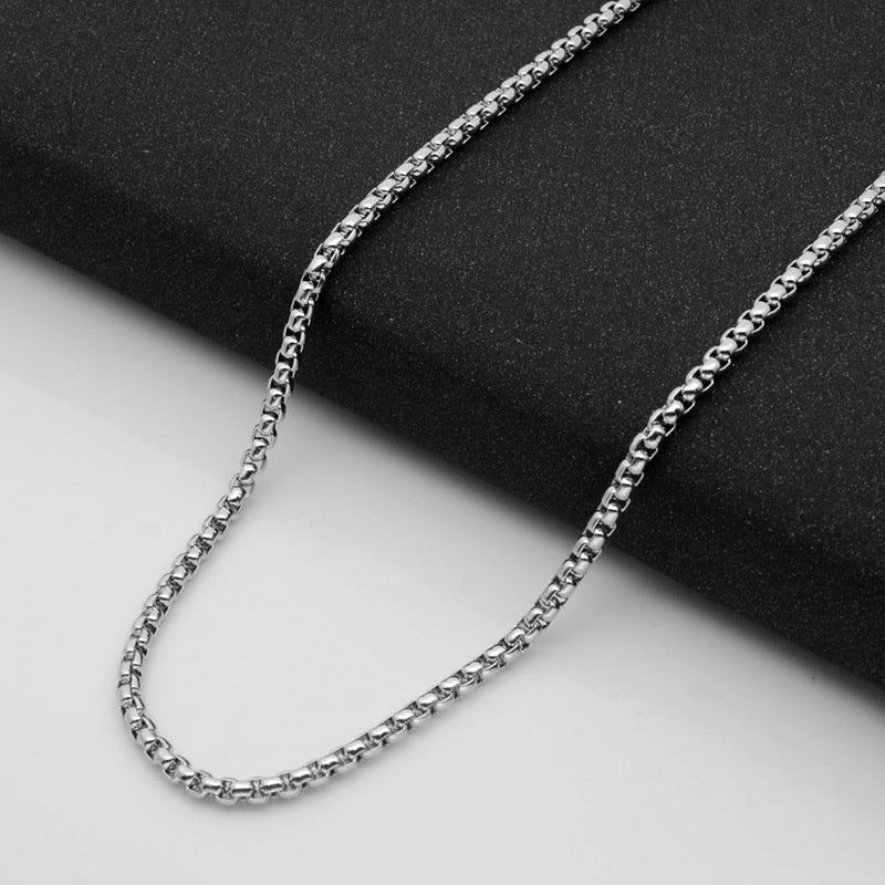 Aramat Jewels silver-colored stainless steel jasseron chain with 3.5mm round links on a black textured background.