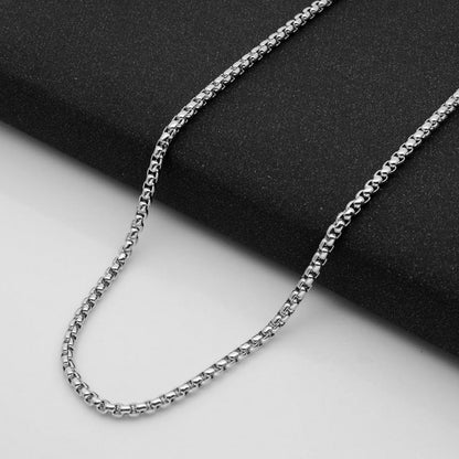Aramat Jewels silver-colored stainless steel jasseron chain with 3.5mm round links on a black textured background.