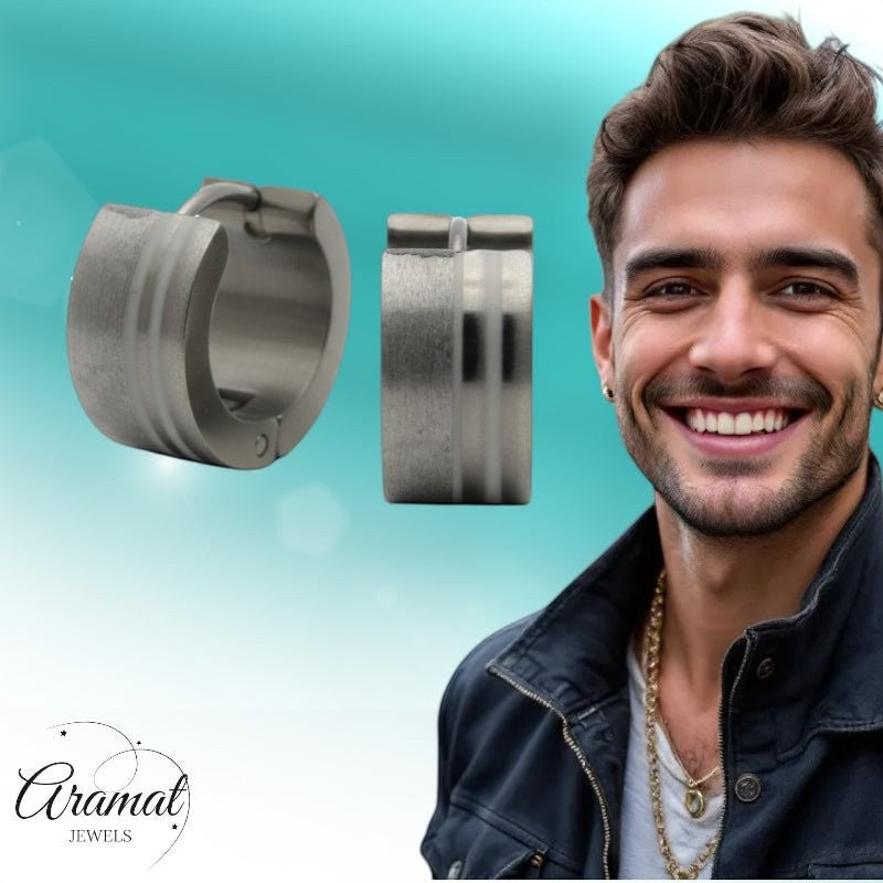 Aramat Jewels sandblasted and polished silver-tone stainless steel hoop earrings (13mm) with contrasting stripes. A smiling man wears one earring.