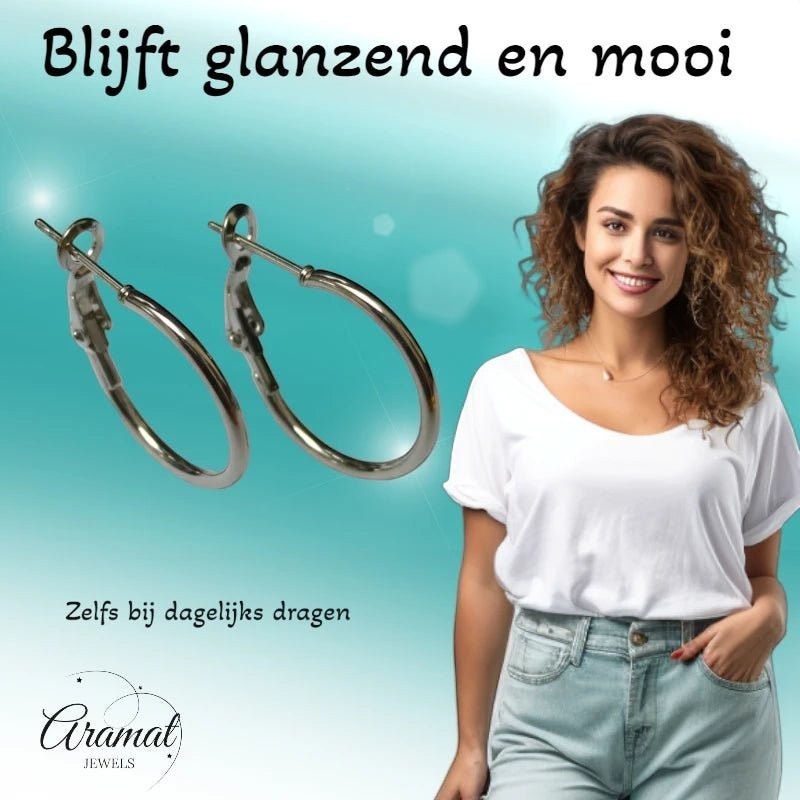 Aramat Jewels silver stainless steel hoop earrings with a high-gloss finish, shown on a smiling woman.