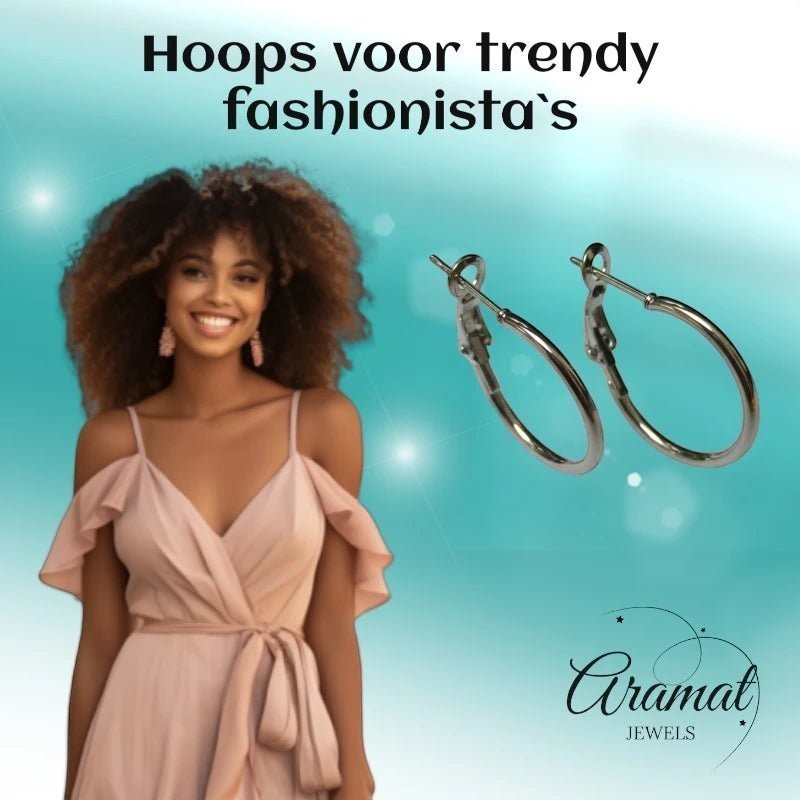 Aramat Jewels silver stainless steel hoop earrings with a high-gloss finish, shown on a smiling model wearing a blush pink dress.
