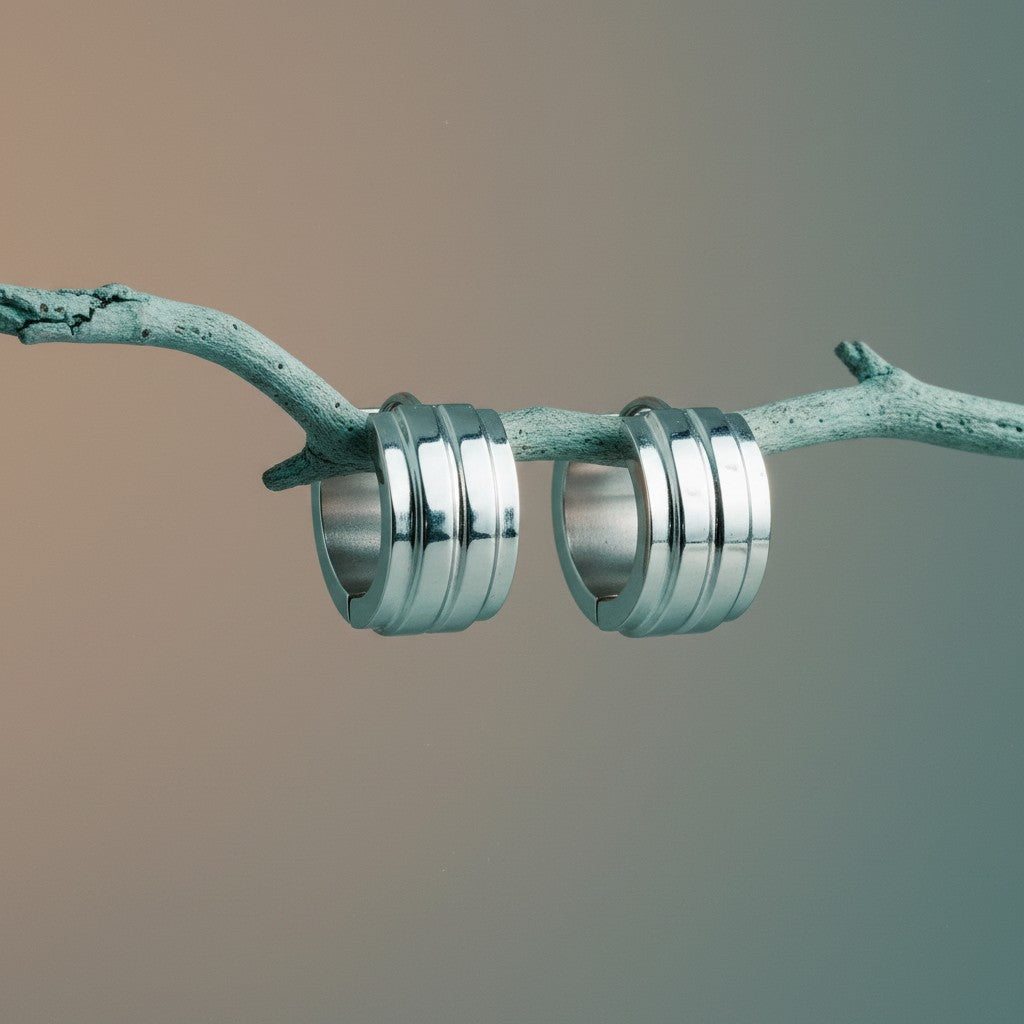 Aramat Jewels silver-colored stainless steel huggie hoop earrings with two raised stripes, 13mm diameter.