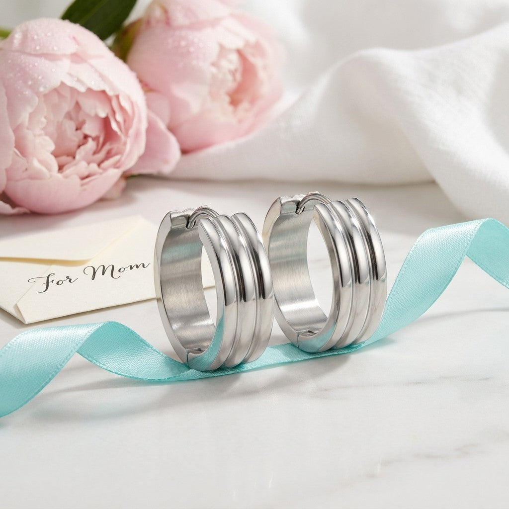 Aramat Jewels wide silver-tone stainless steel hoop earrings with ribbed detail, 13x7mm.