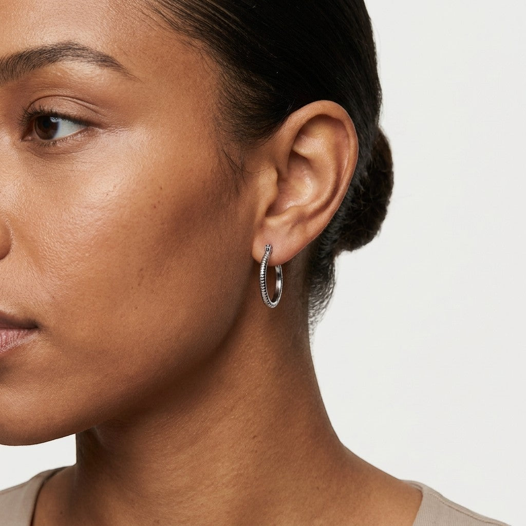 Aramat Jewels silver-tone stainless steel hoop earrings with a striped texture, 18mm diameter.