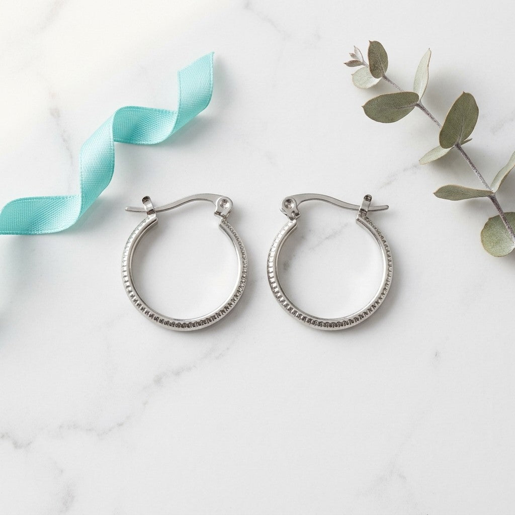Aramat Jewels silver-tone stainless steel hoop earrings with a striped texture, 18mm diameter.