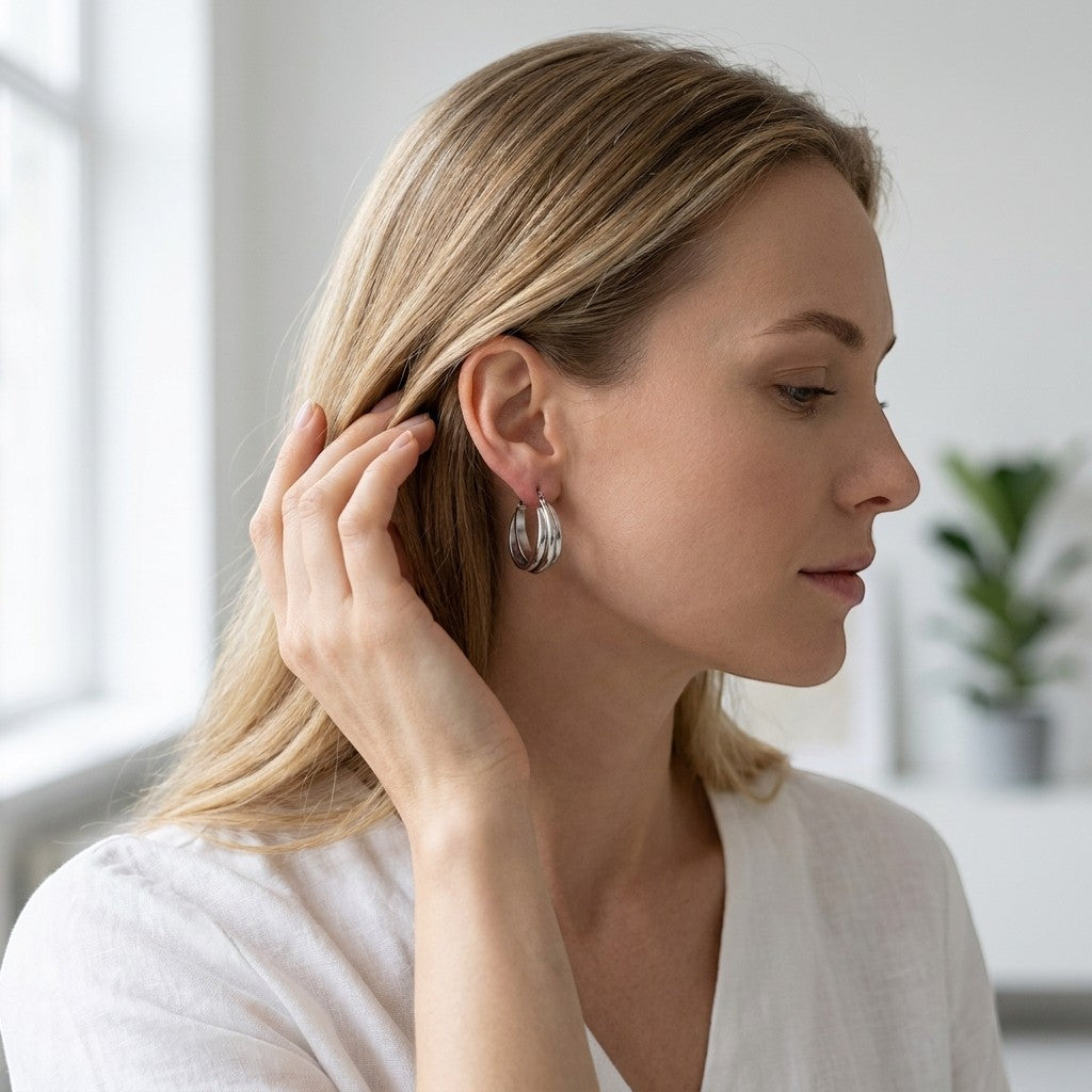 Aramat Jewels silver-tone triple hoop earrings with a crossed design, made of stainless steel.