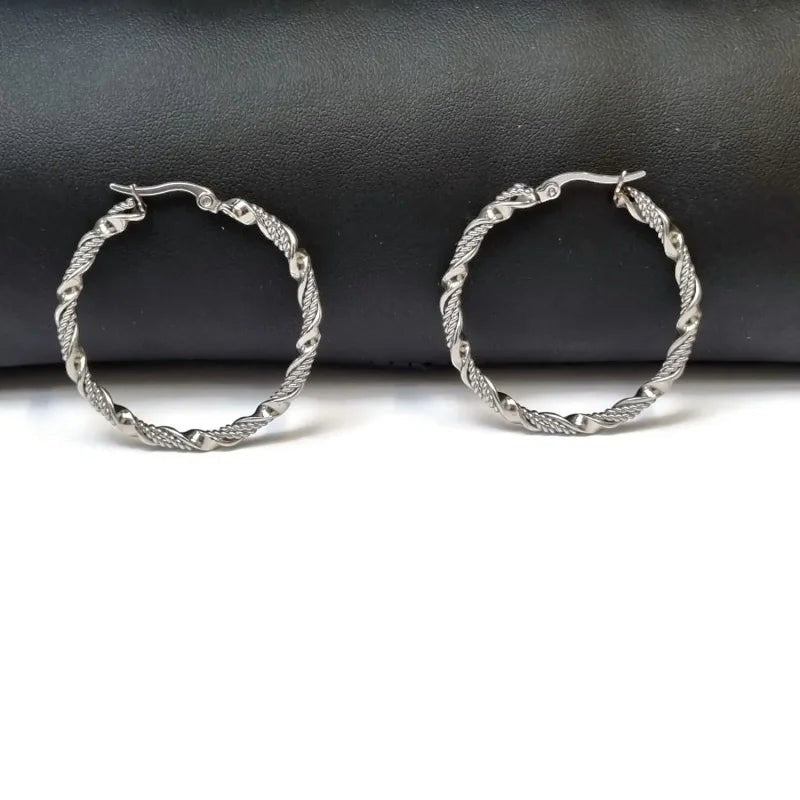 Aramat Jewels silver-tone stainless steel twisted hoop earrings, 30mm or 40mm diameter, 3mm width, with a secure clasp.