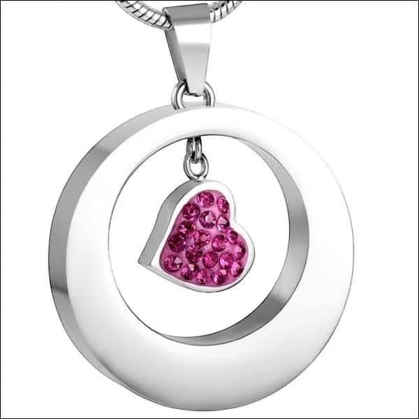 Aramat Jewels® zilverkleurige stalen ashanger rond met een hartje bezet met roze steentjes.