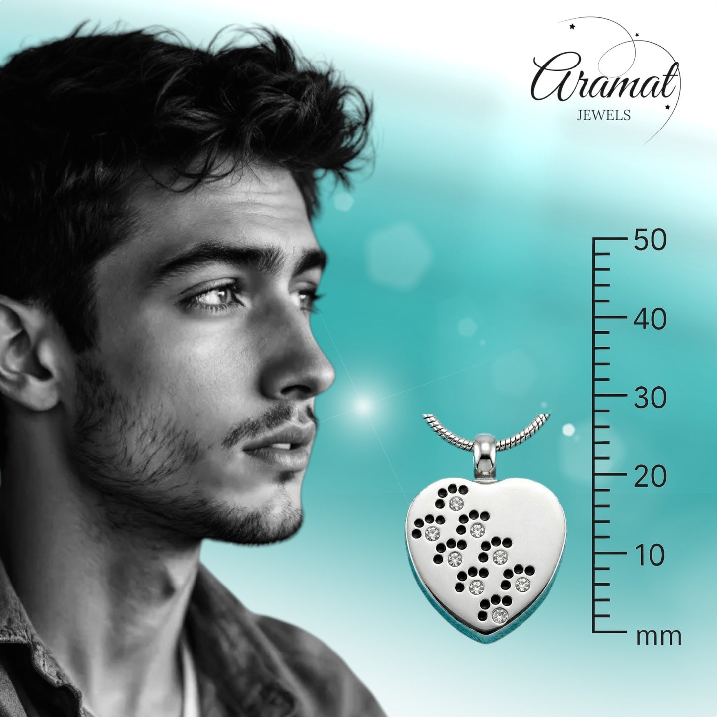 Aramat Jewels zilverkleurige stalen ashanger in hartvorm met pootjes en zirkonia steentjes.
