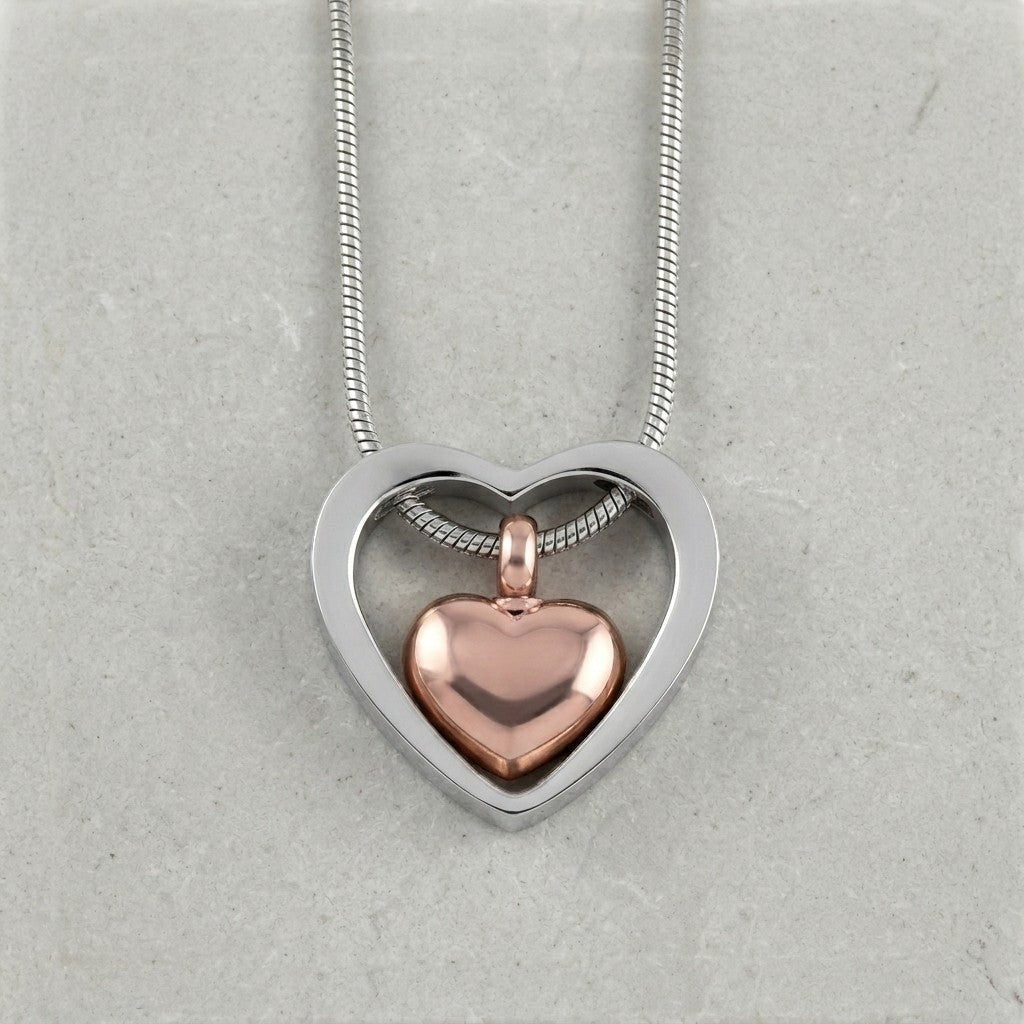 Aramat Jewels stalen hart crematiehanger in zilverkleurig en rosékleurig. Gedenksieraad met schroefsluiting, zonder ketting.
