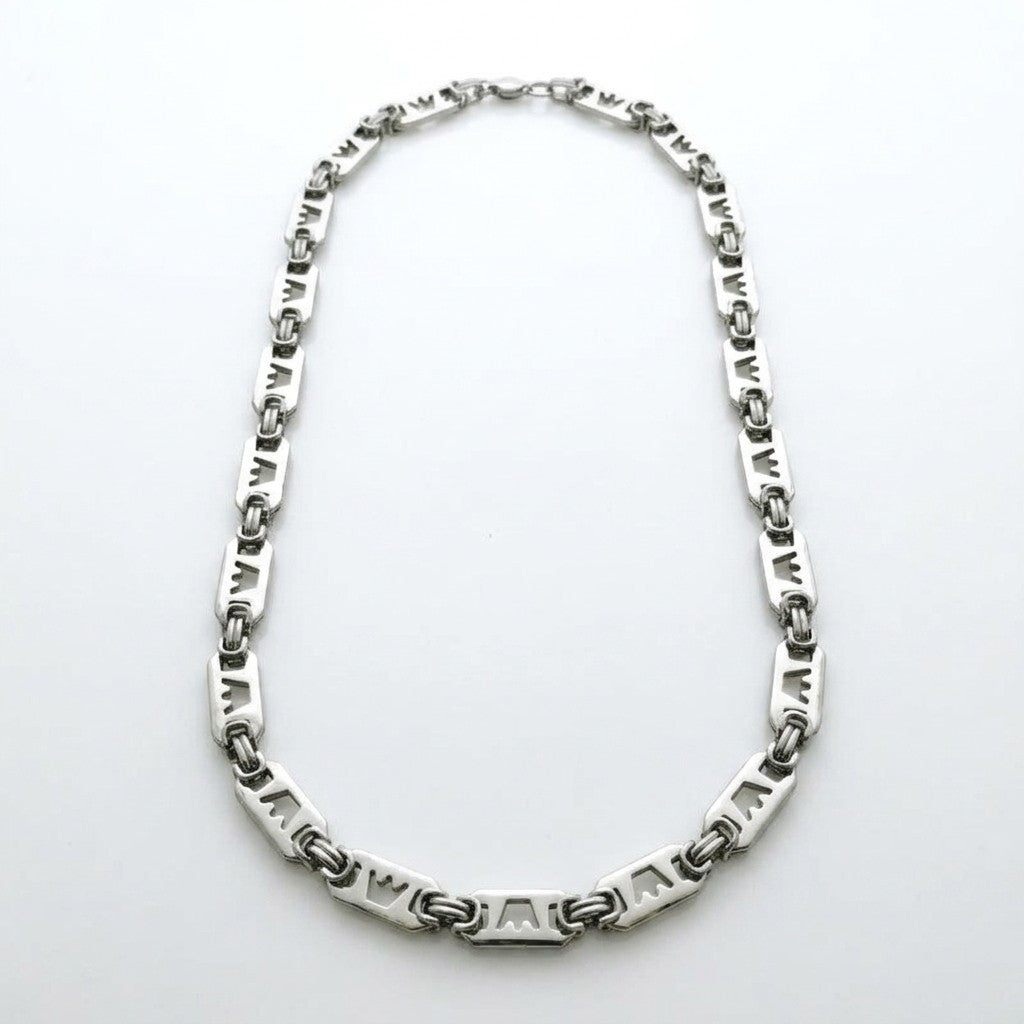 Aramat Jewels brede zilverkleurige roestvrijstalen koningsketting met unieke schakels voorzien van kroonmotieven.