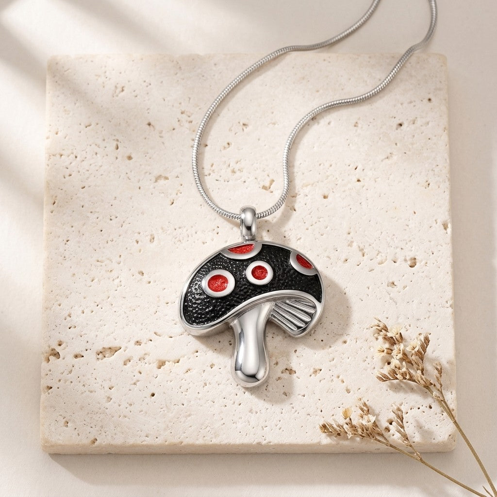 Aramat Jewels stalen paddenstoel ashanger met rode emaille stippen, zilverkleurig en zwart.