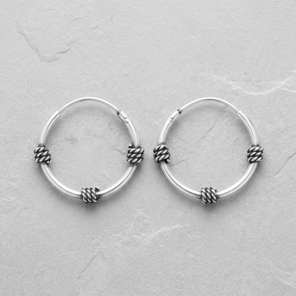 Aramat Jewels thin 16mm sterling silver Bali hoop earrings with intricate rope detailing.