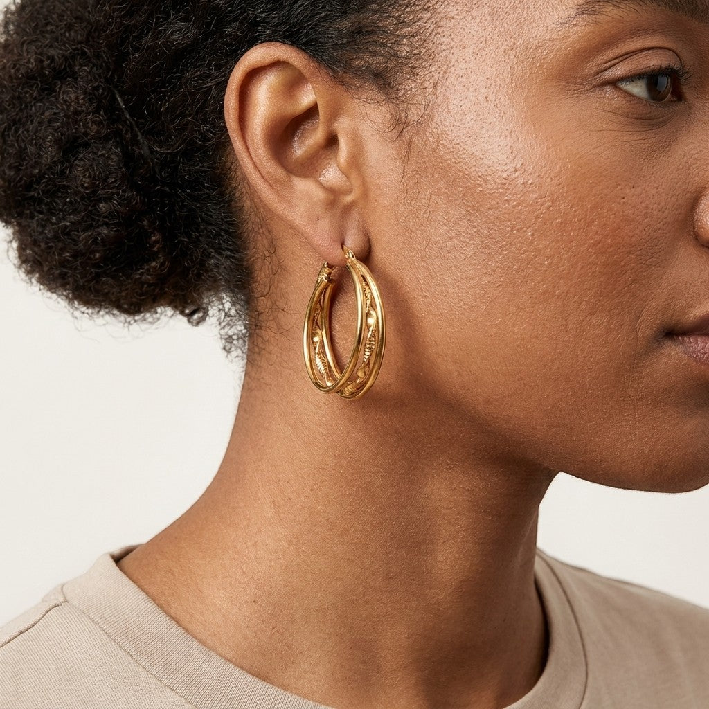 Aramat Jewels triple gold hoop earrings with a twisted and smooth design, 30x7mm, worn by a model.