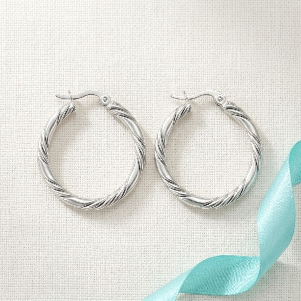 Aramat Jewels silver-tone stainless steel twisted hoop earrings, 30mm diameter, with a unique 3-strand design.