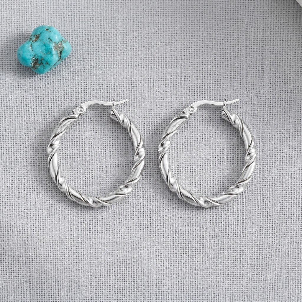 Aramat Jewels silver-tone stainless steel twisted hoop earrings, 30mm diameter, with a two-strand design.