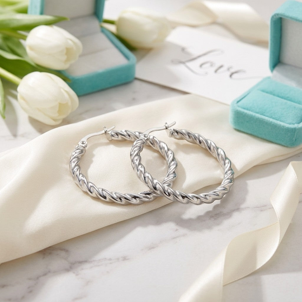 Aramat Jewels silver-tone stainless steel twisted hoop earrings, 30mm diameter, elegant and modern design.