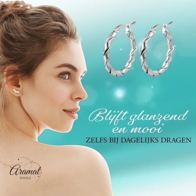 Aramat Jewels silver-tone stainless steel twisted hoop earrings, 25mm or 45mm, worn by a model.
