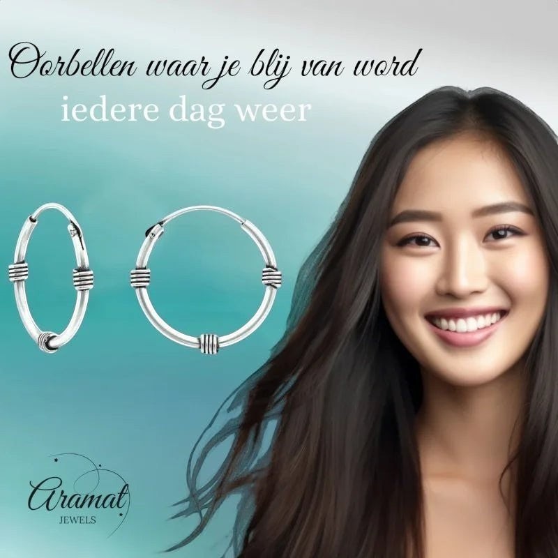 Aramat Jewels unisex silver Bali hoop earrings, 16mm diameter, with decorative bands. Model with dark hair smiles.