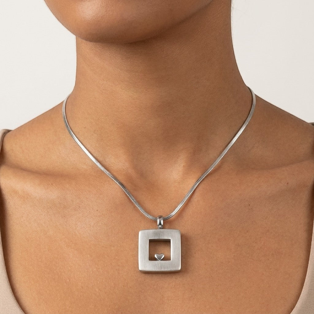 Aramat Jewels zilverkleurige vierkante ashanger met hartje, 26x19mm, van roestvrij staal.