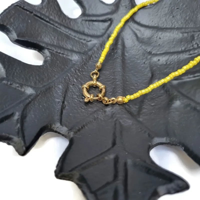 Aramat Jewels yellow seed bead necklace with gold clasp and accents, 42cm length.