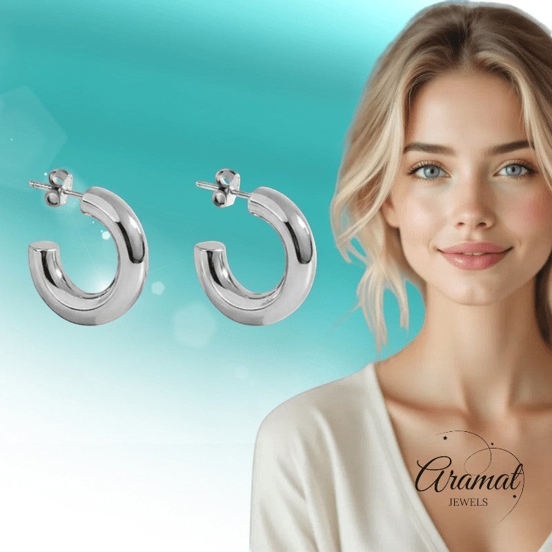 Aramat Jewels massieve zilverkleurige halve oorringen van glad RVS, 25x8mm, voor een moderne look.