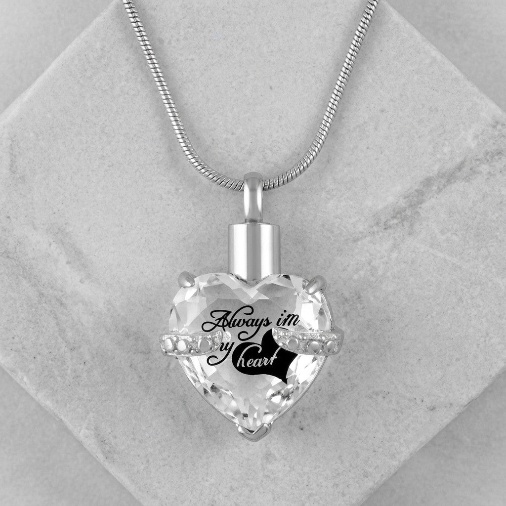 Aramat Jewels zilverkleurige hart crematiehanger van 316L staal met zirkonia en gravure 'Always in my heart'.