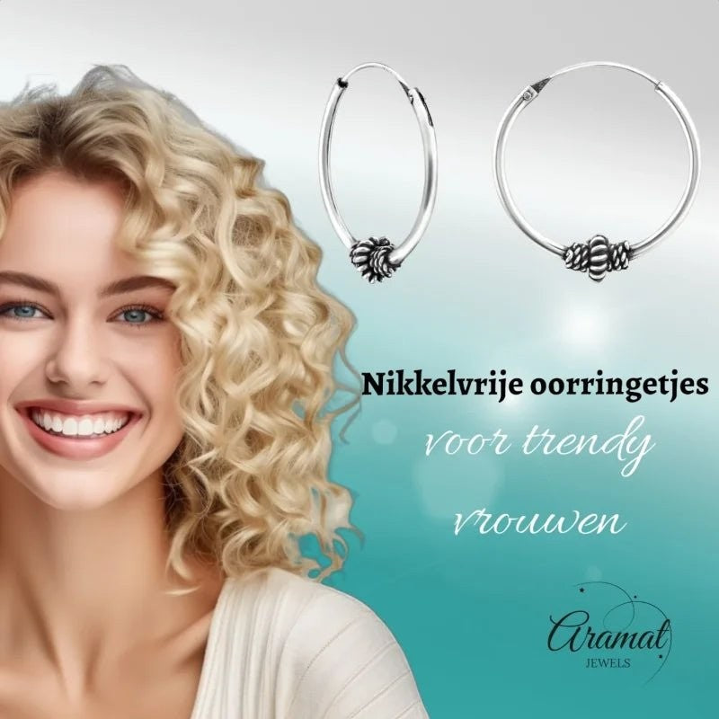 Aramat Jewels 18mm silver Bali hoop earrings with ethnic design, worn by a smiling woman with blonde curly hair.