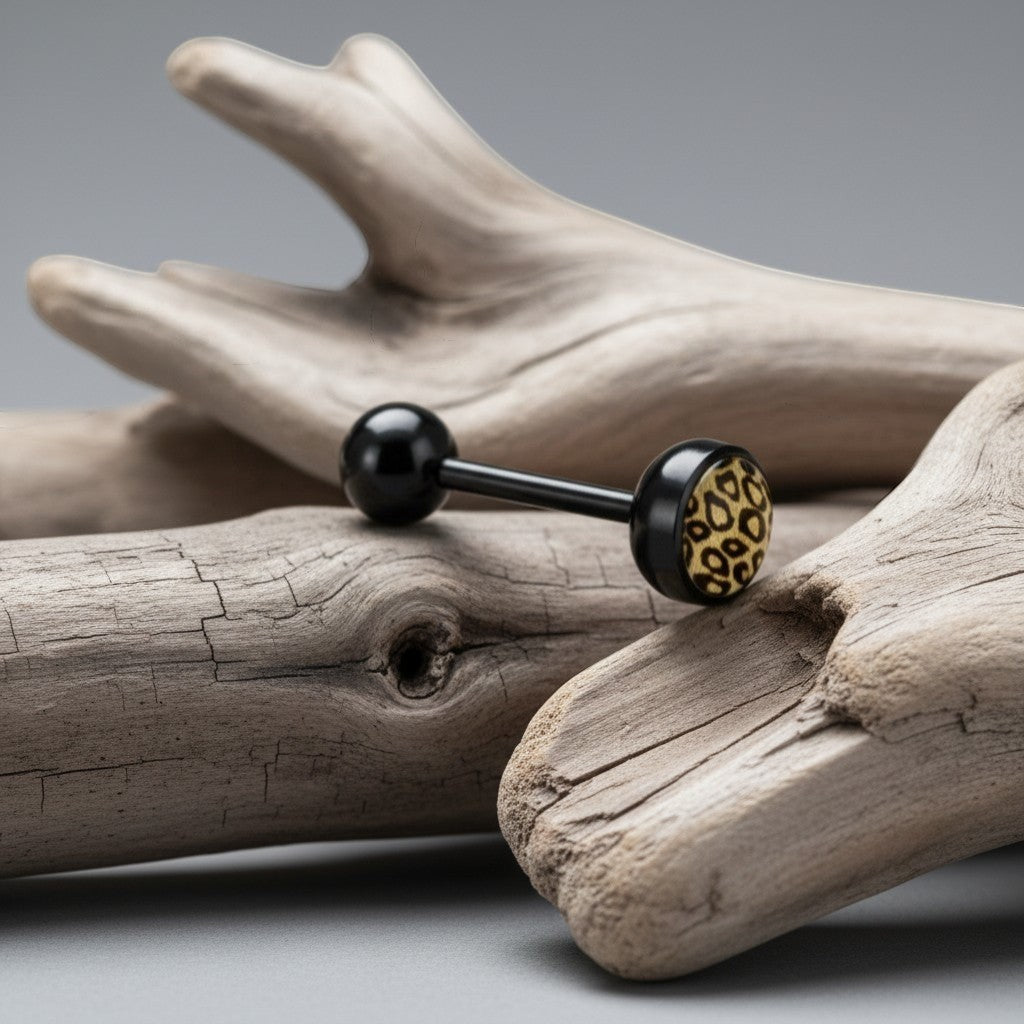 Aramat Jewels black bioplast tongue piercing with a leopard print design on one ball. 16mm length, 1.6mm gauge.