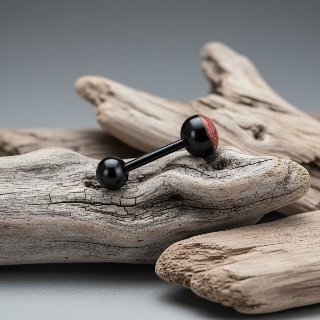 Aramat Jewels black bioplast tongue piercing with a red animal print design on one ball.
