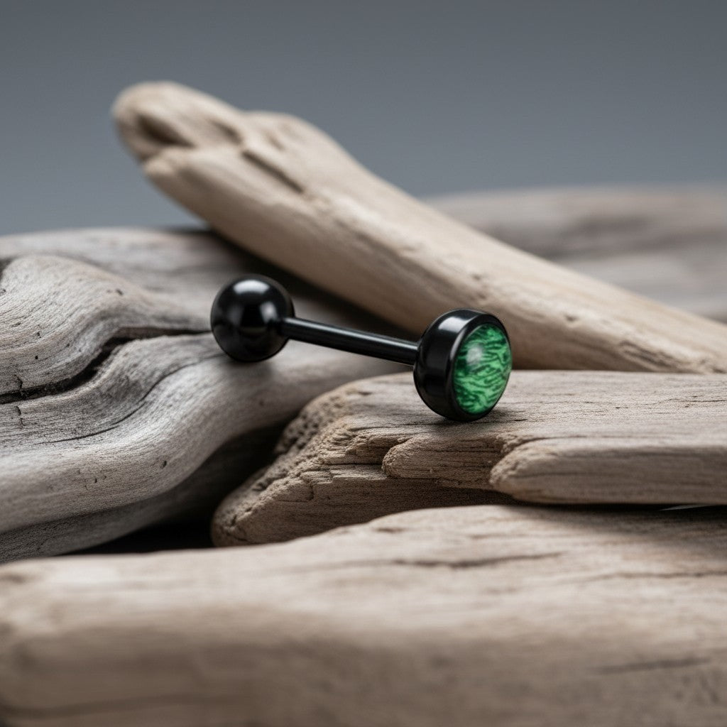 Aramat Jewels black bioplast tongue piercing with a green animal print design on one ball.