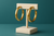 Elegant gold-colored hoop earrings against teal background